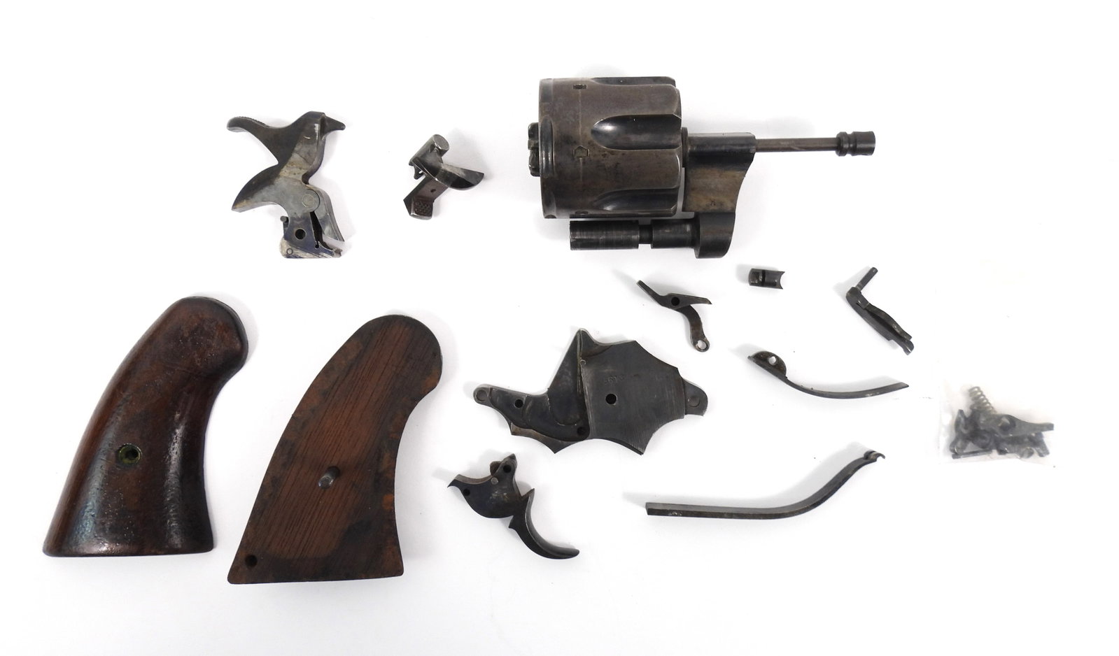 Colt Model 1892 Double-action .38 Parts Kit.: Lot consisting of a broken down Colt Military double action military revolver pre 1901 lanyard improvement with inspector cartouche wood grips. Not including the frame or barrel.