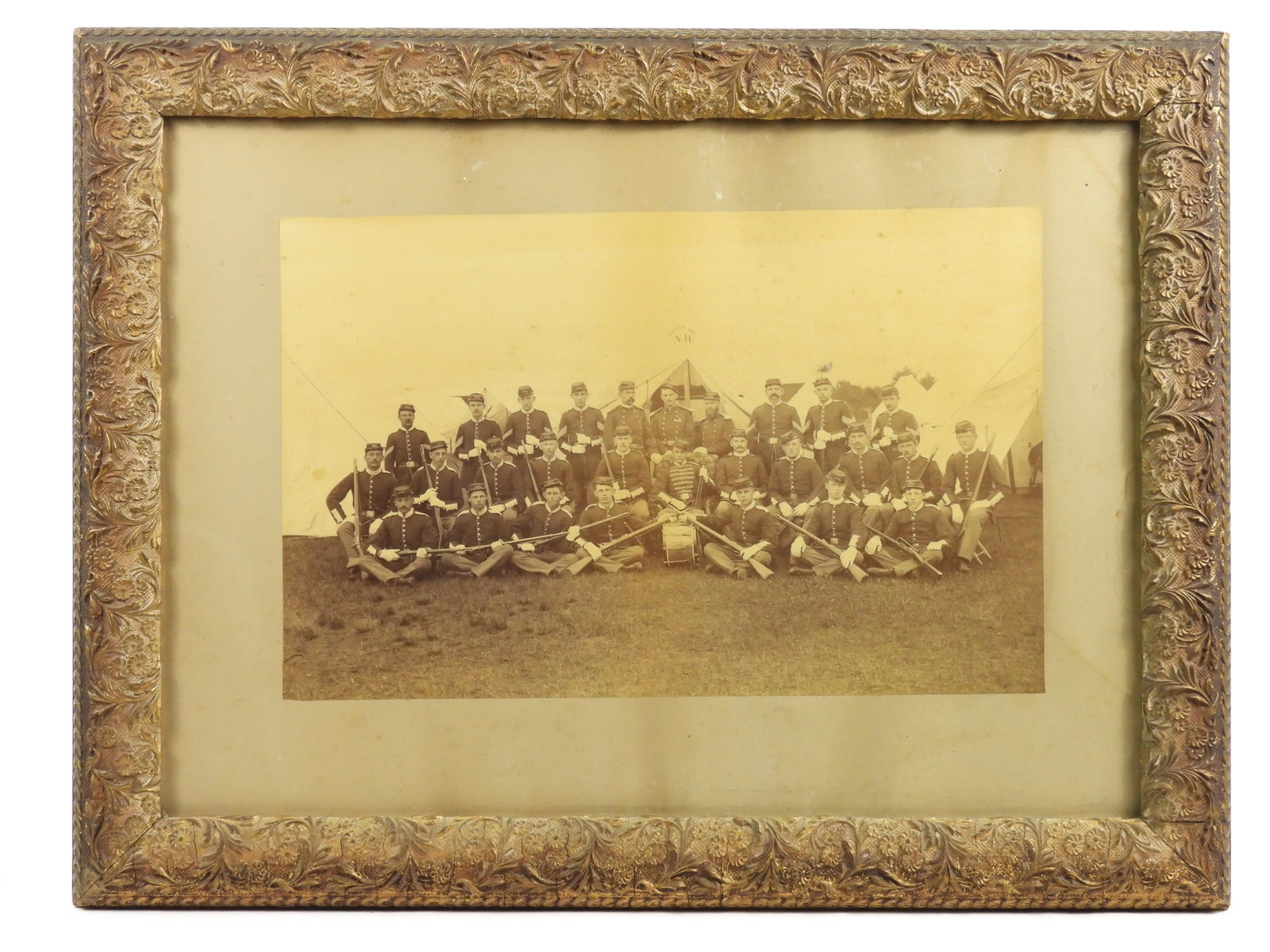 Post Civil War New Hampshire Volunteers Photograph: Nice military photo of Company D in the New Hampshire National Guard. Each member is holding a trapdoor rifle. Center rear row officer appears to have civil war veteran medals affixed to his uniform. 