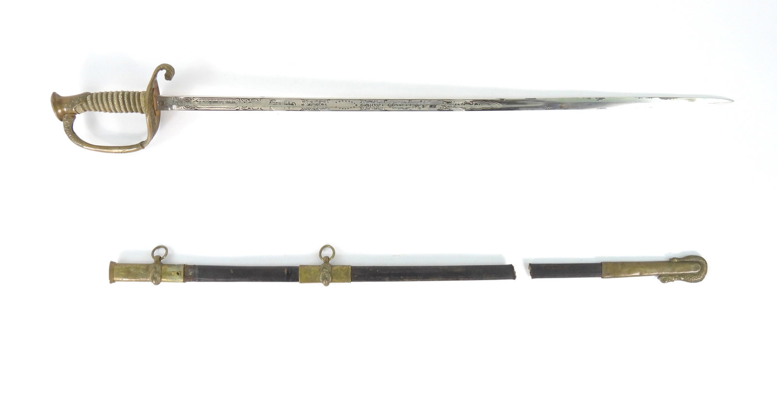 USN Model 1852 Sword Identified to Newman K. Perry: Brass hilt with patriotic and foliate designs, wire-wrapped shagreen grip, steel blade with engraved foliate and patriotic designs marked on the ricasso "PROVED" in a star, marked on the other side of