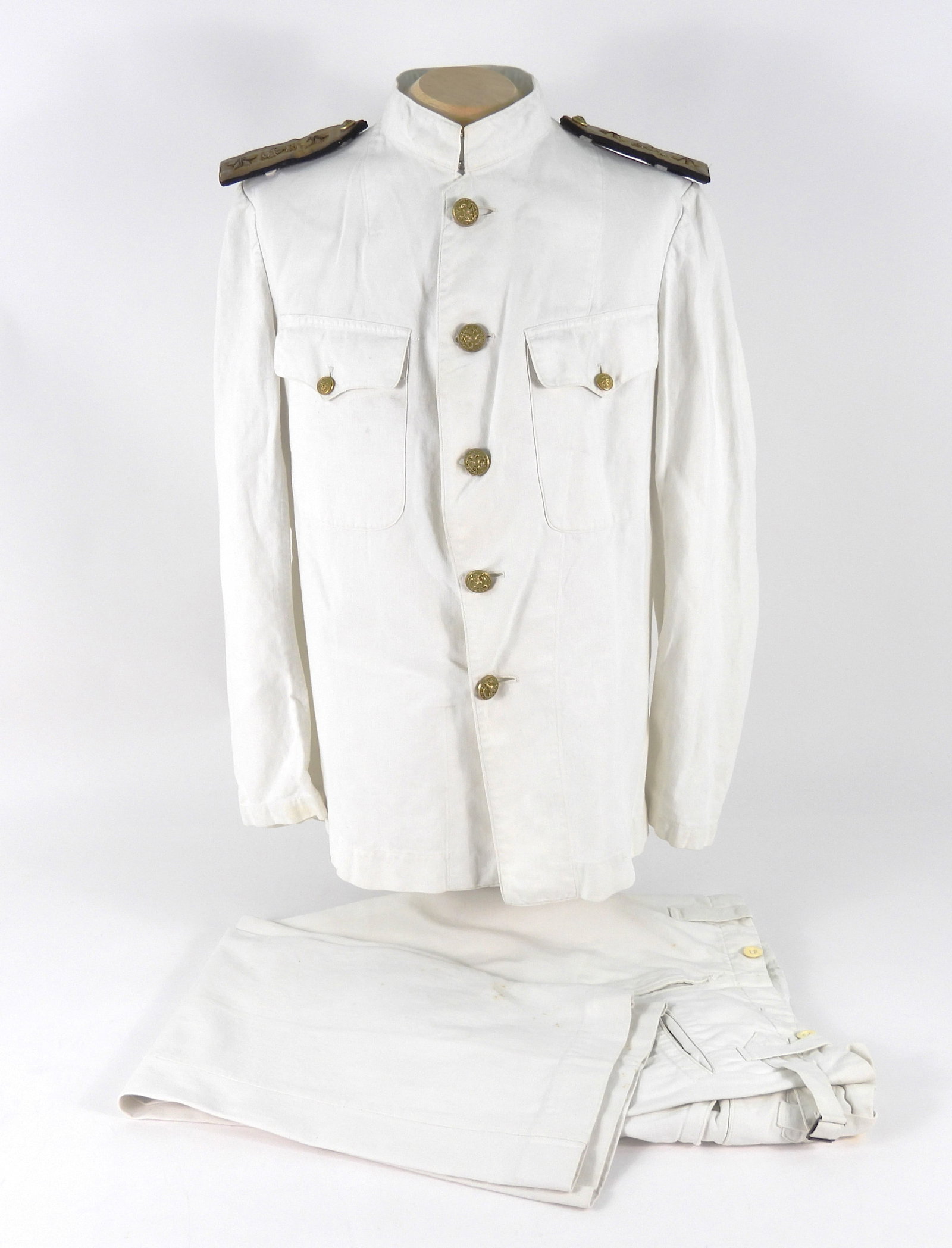 USN Uniform of Rear Admiral William Wirt Kimball: White plain woven cotton tunic with brass U.S. Navy buttons, two breast pockets, rear admiral shoulder boards, marked inside the collar "Kimball", and a pair of matching white plain woven trousers, ma