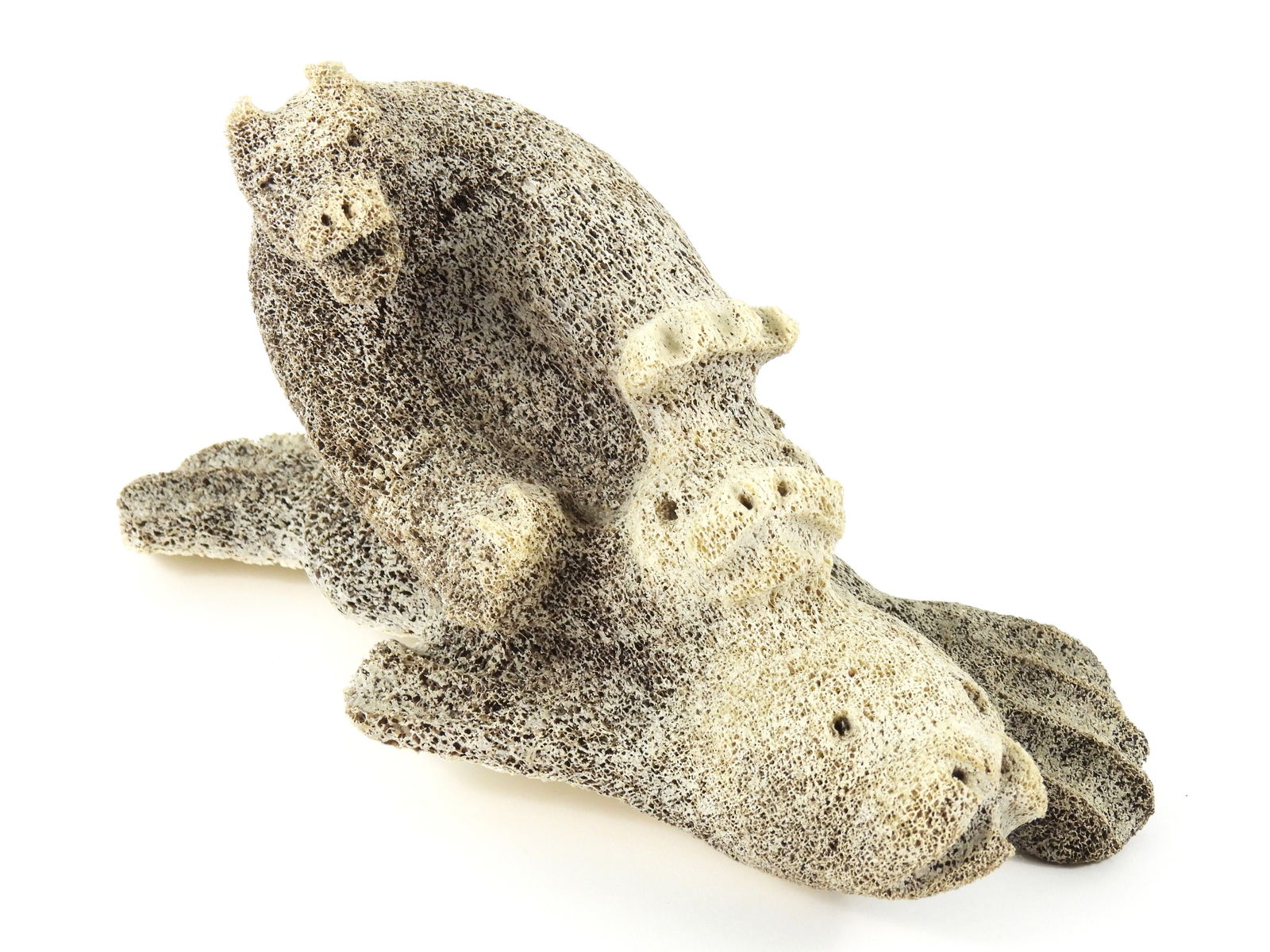 Inuit Petrified Whale Bone Sculpture: 20th Century, Bone. Carved bone depiction of a polar bear on the backs of two seals of varying sizes. From the collection of a Princeton, Massachusetts estate.