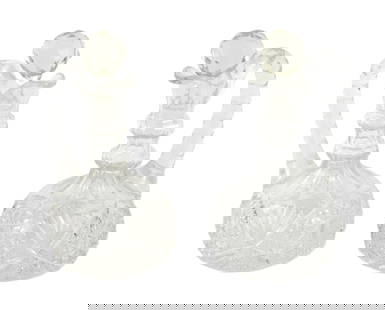 PR Cut Glass Cruets: United States, 20th Century, Glass. Pair of clear cut glass cruets with faceted stoppers and star patterns to body. Each approx. 7 1/2" x 4 1/2" dia.