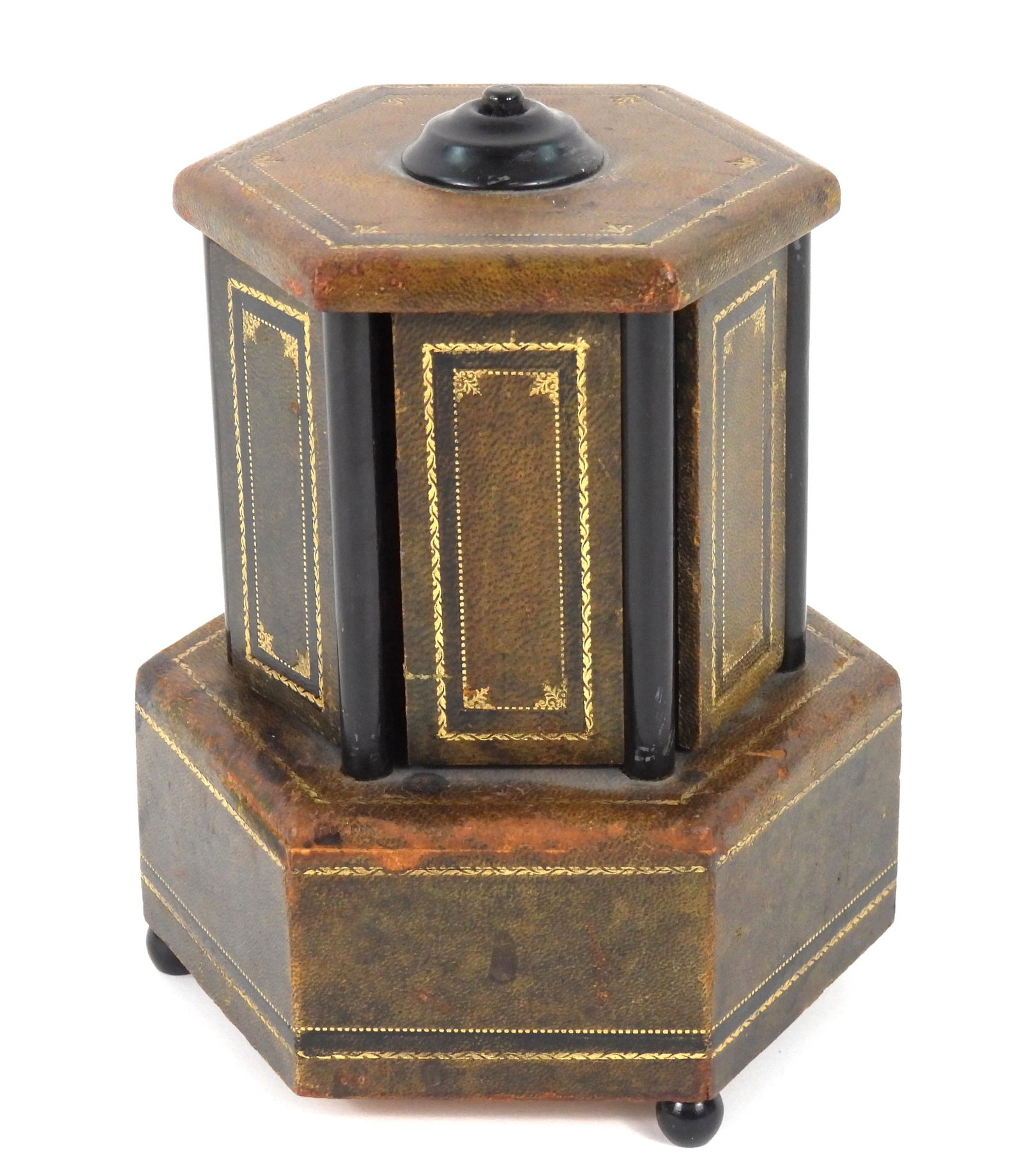 Februholz no. 5974/L Music Box Lipstick Holder: Austria, Early-Mid 20th Century, Wood, leather. Hexagonal leather covered wood lipstick music box with gilt accents and six holders that open and close when music plays. Approx. 7 1/2" x 6" dia.