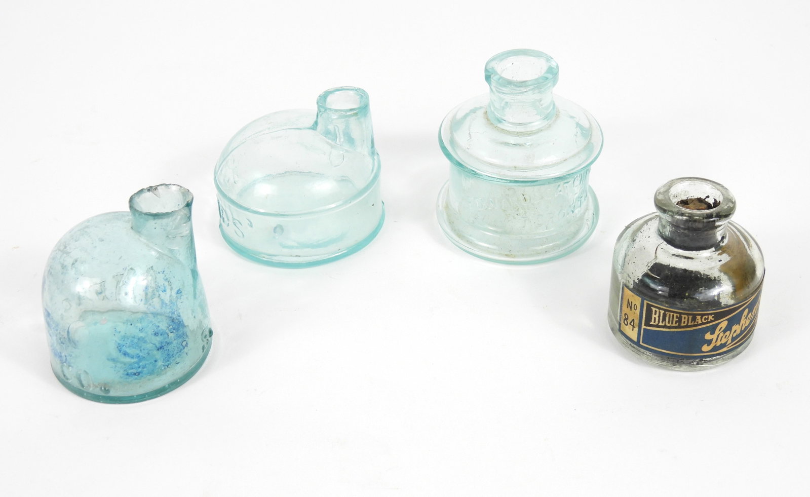 4PC Early Inkwell Bottles: 19th-20th Century, Glass. Edward Catchpole & Co. Toronto Aqua color glass that has a 1/4" lip chip measuring 2 1/2" x 2 1/4"; a Davids' marked Igloo aqua color glass inkwell with some tick chips to st