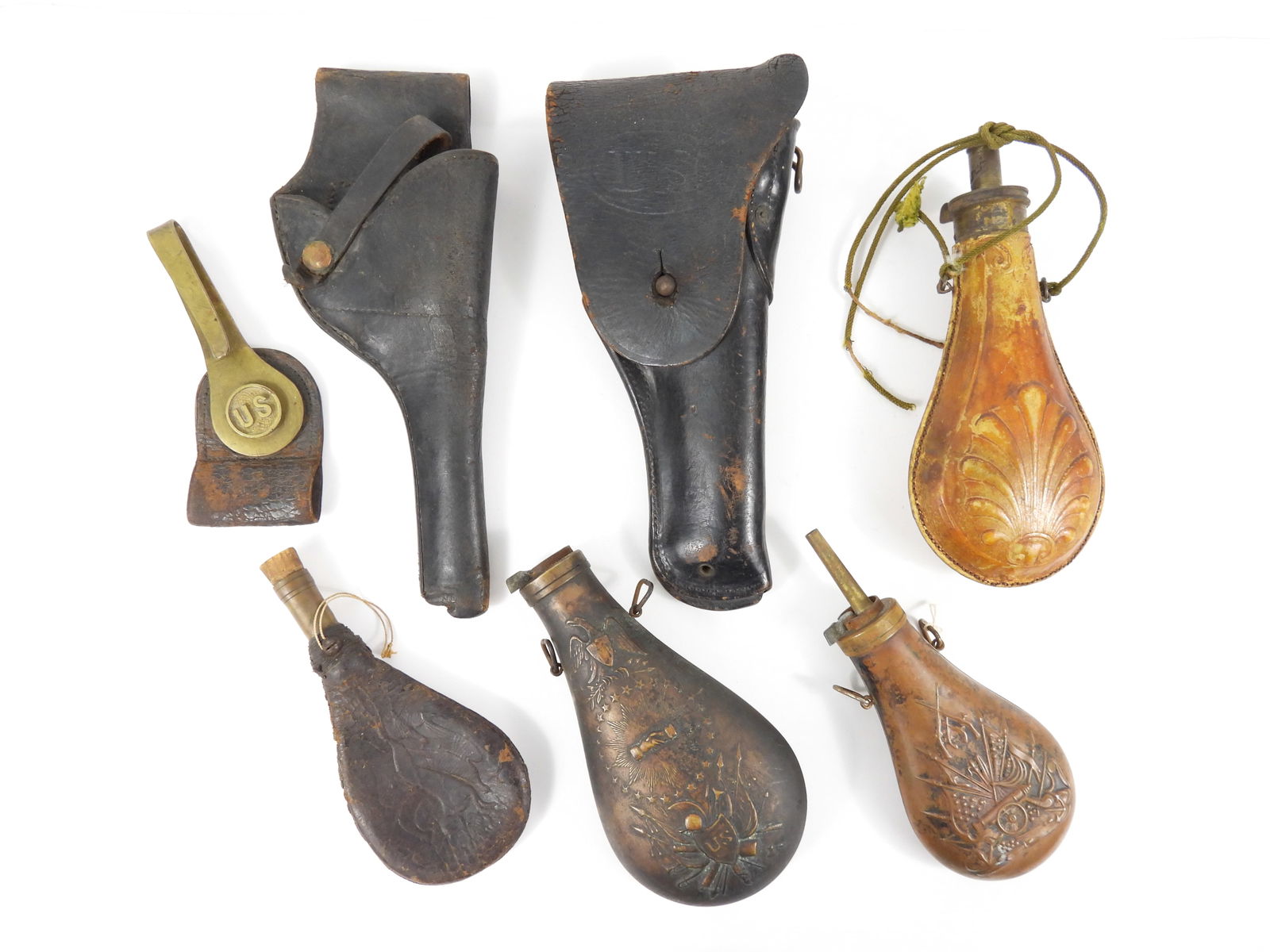 7PC Military And Hunting Items: 19th Century. Includes four powder and shot flasks, two are military type, two revolver pistol holsters with one being stamped U.S., and one trapdoor bayonet hanger.