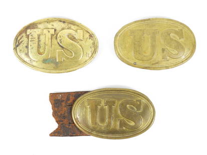 Three Civil War Era US Belt Plates: United States. Three US Civil War-era belt plates with arrow style attachment hooks on the back. One buckle has retained a piece of original belt.