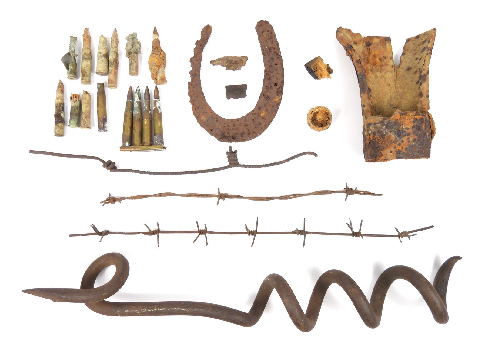 Group of WWI Relics: 1914-1918. Group of assorted WWI relics from the battlefields in France, including part of an exploded shell, several bullet shell casings, a corroded stripper clip with 4 corroded rifle bullets,3 pie