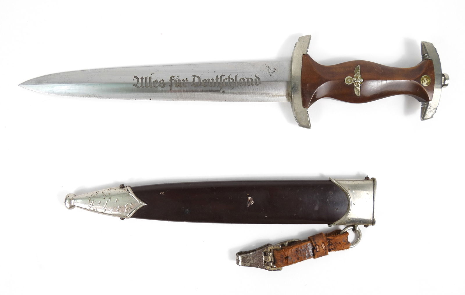 WWII German German SA Dagger: Germany, Circa1930-1940. Brown wood grips with "SA" disc, eagle, and swastika. Blade marked "Alles fur Deutschland" on one side of the blade, and "RZ/M/M7/85" on the other side, and a brown-painted sc
