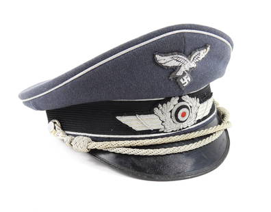 WWII German Luftwaffe Officer's Visor Cap: Germany. Blue-gray twilled wool cap body, silver piping, embroidered insignia, silver chinstrap, black bound edge visor, gray liner with makers stamp on plastic, and a brown leather sweatband.