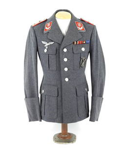 WWII German Luftwaffe Flak Captain's Tunic: Germany. Blue/gray superfine broadcloth body, captain's shoulder boards, flak collar tabs, silver braid around the collar, and embroidered Luftwaffe eagle, a ribbon bar over the left pocket, an anti-a