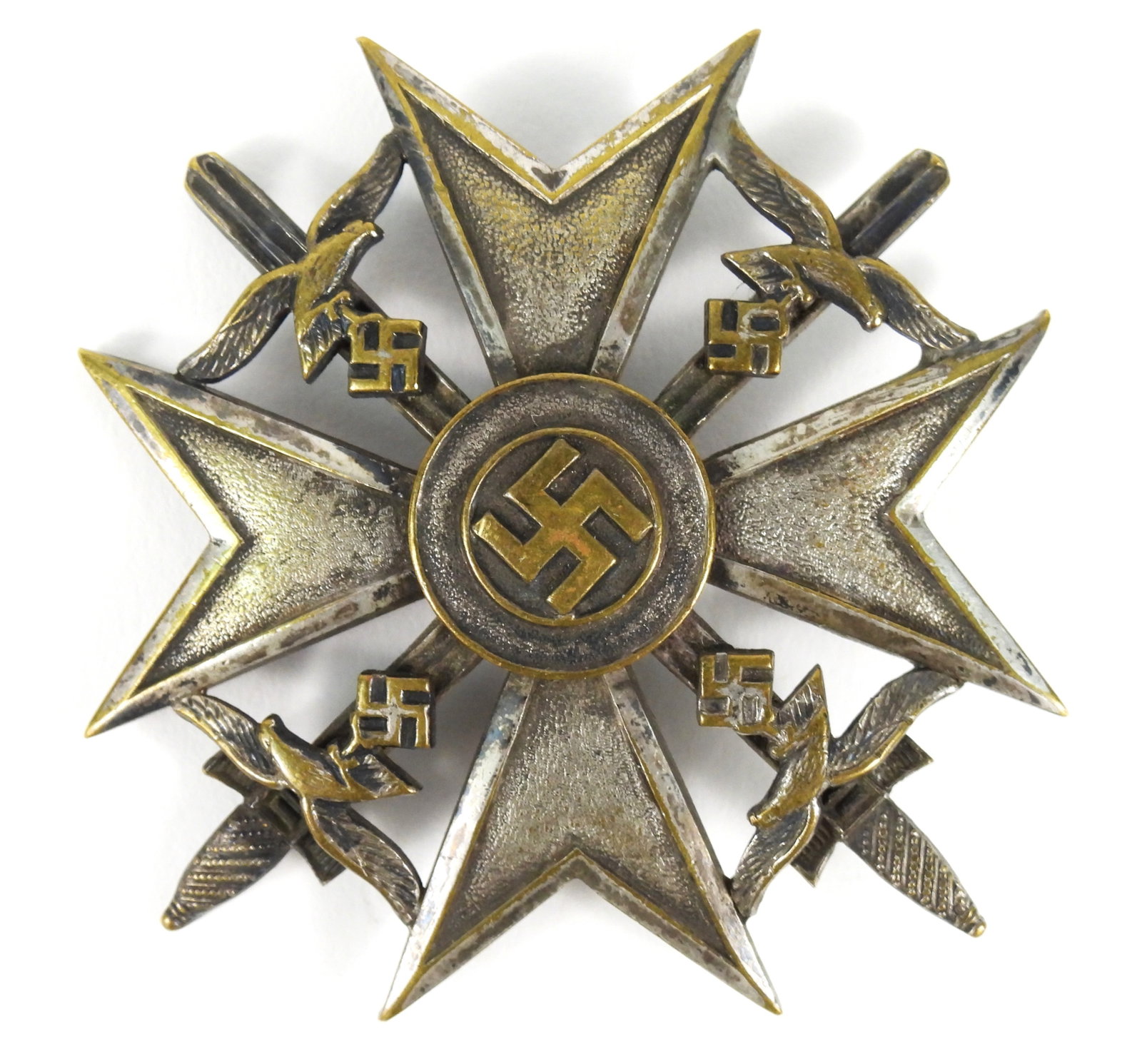 WWII German Spanish Cross with Swords: Germany. Silver-washed bronze medal with swords, Luftwaffe eagles, a cross and a central swastika, no maker markings visible on the back, and a pin. Overall 2 1/2" tall