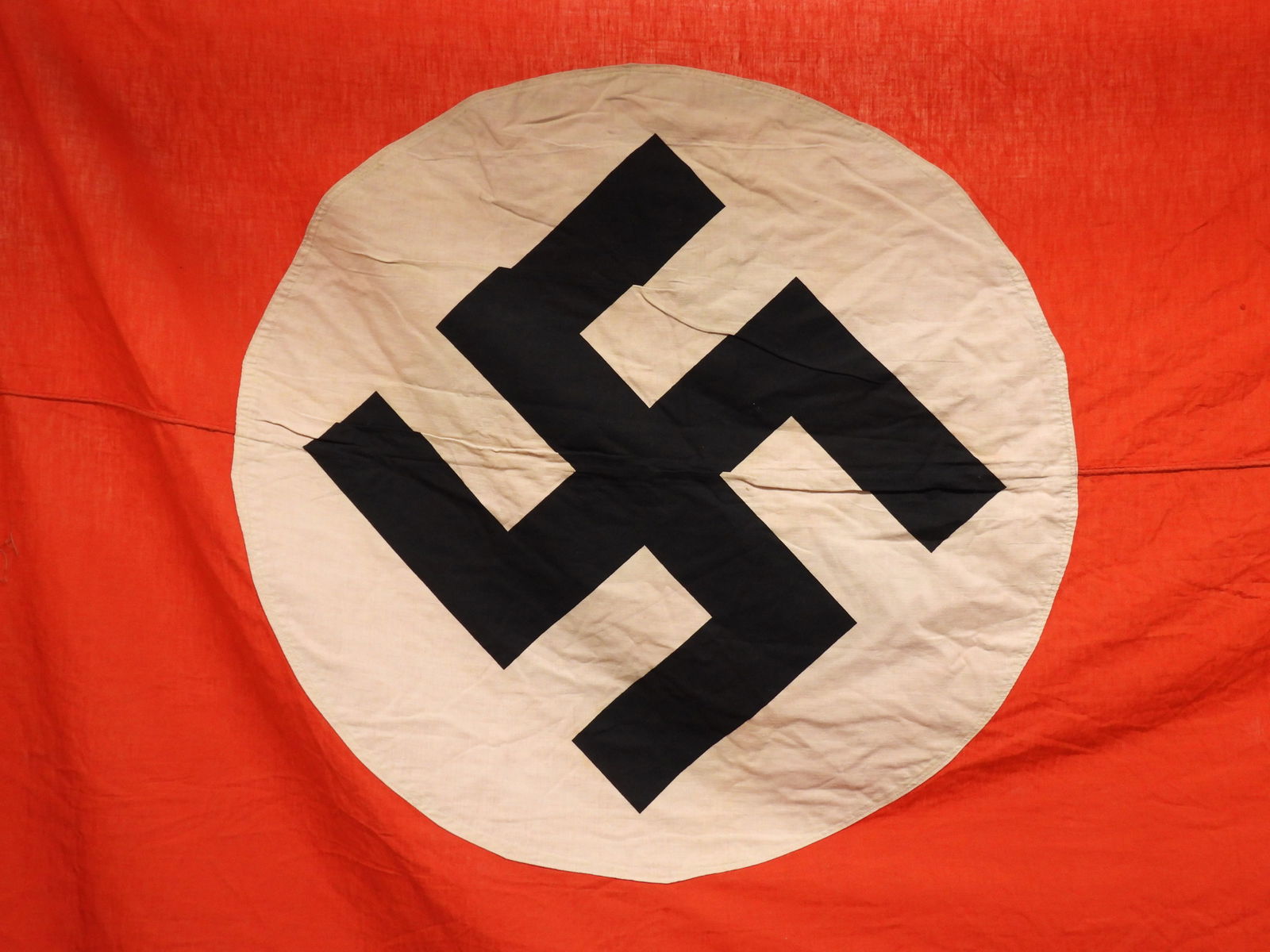 LG WWII German Banner: Germany, Mid 20th Century. Large red cotton banner with applied white central circle and black printed swastika. Approx. 13' 5" x 4' 10"