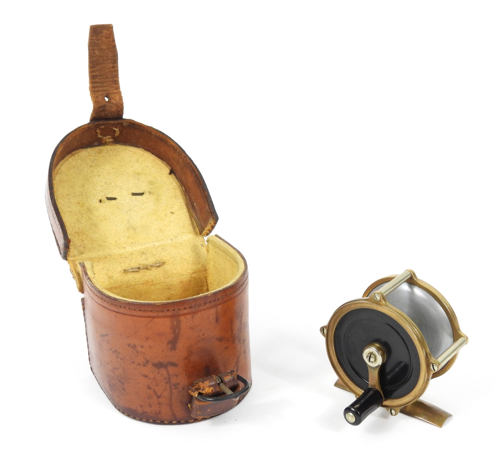 H.L. Leonard 191813 Bi-Metal Fly Reel: United States, Circa 1930, Metal, leather. Bronze, nickel silver, and aluminum constructed fly reel with ebonite face plates and bone button. Includes a leather case from New York based dealers Willia