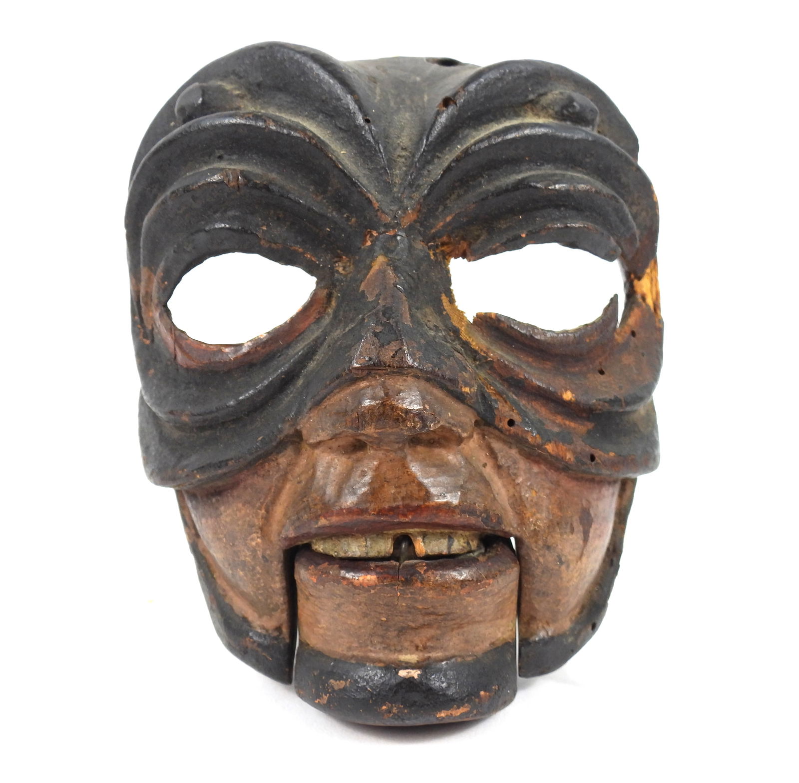 Carved Wood Asian Mask: Asia, Early 20th Century, Wood. Carved wood mask with weighted articulated jaw and deep grooves around the eye holes.