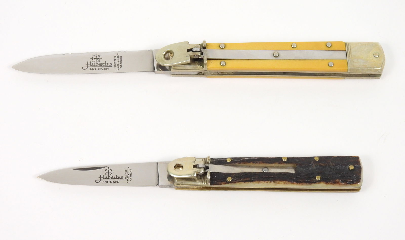 2PC Hubertus German Knives: Germany. Both are lever lock blade Solingen springers, one with a bone handle and one with a stage grip handle.