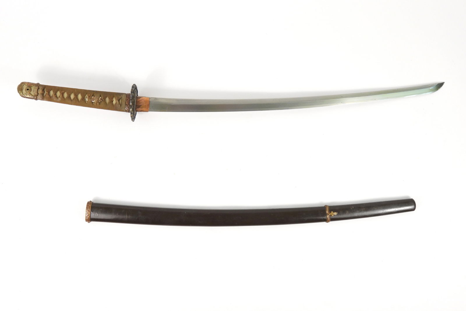 WWII Japanese Katana: Japan, C. 1941. Tape-wrapped shagreen grip, marked tang (see images) to Koa Isshin Manetsu Saki Kore, copper habaki, steel blade, and a green-painted scabbard.