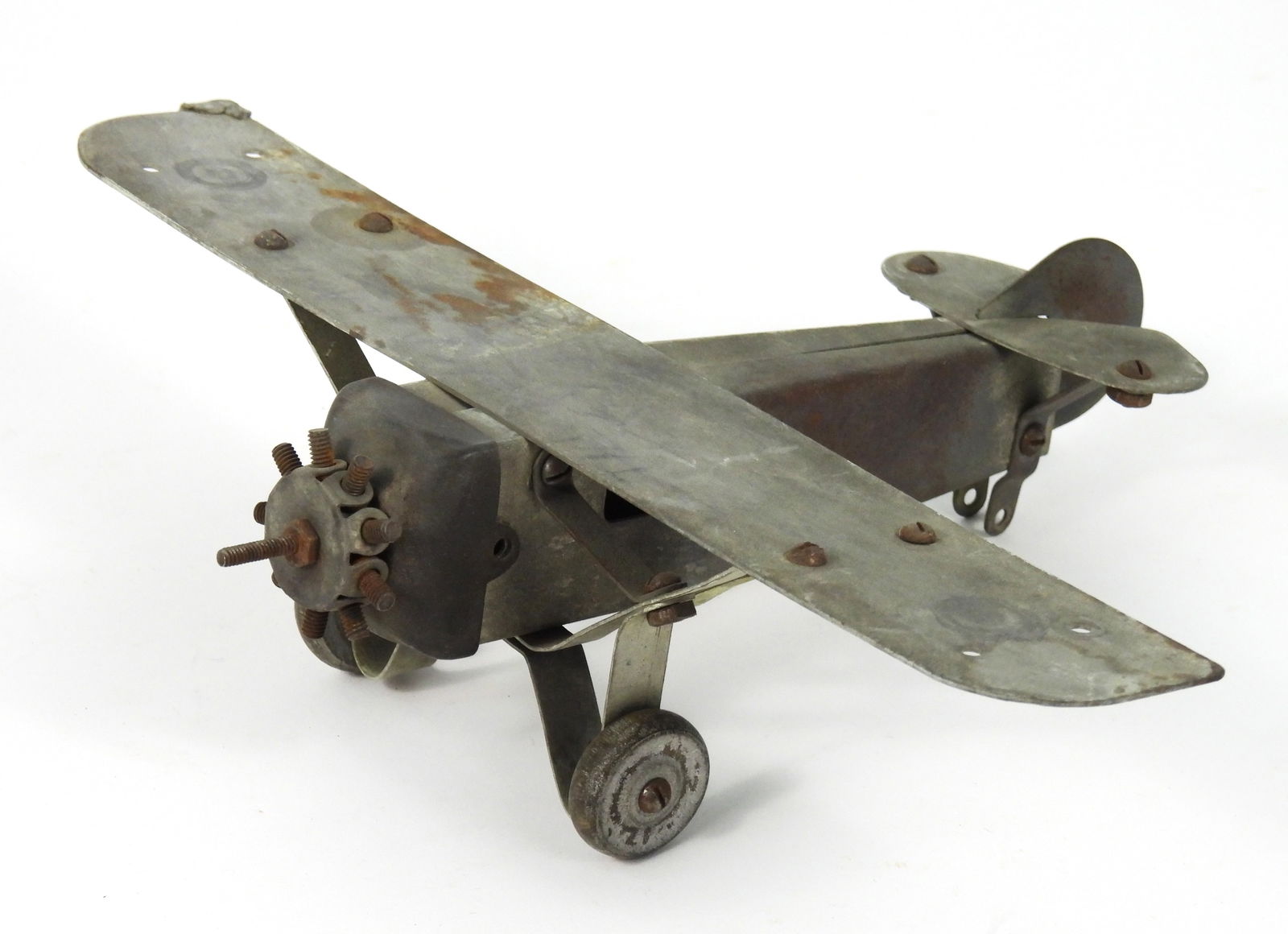 Attr. Metalcraft Spirit of St. Louis Model Plane: United States, Early 20th Century, Metal. Metal toy plane with old pencil decorations featuring roundels and an eagle, aptly named "The Black Eagle." Approx. 3" t x 11 1/2" w x 8 1/2" d