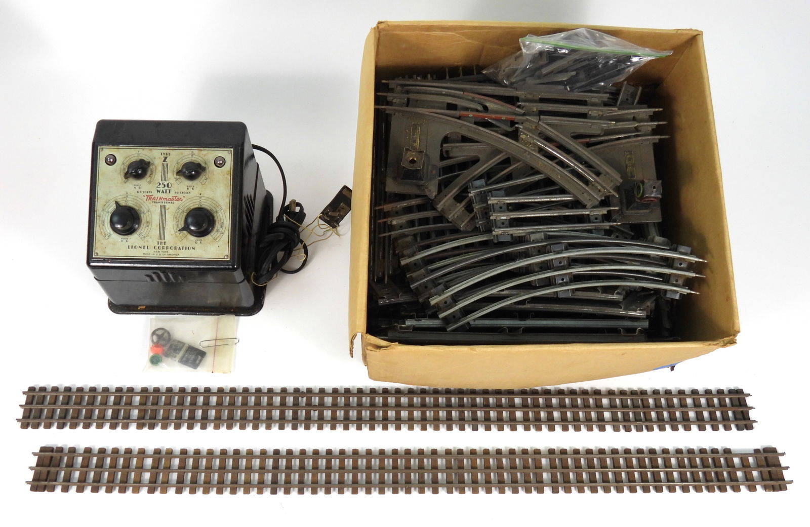 Collection Lionel Train Tracks & Transformer: United States, 20th Century, Metal. Includes an assortment of over 70 sections of track, including two 36 inch straight sections, and a Lionel type z 250 watt transformer.