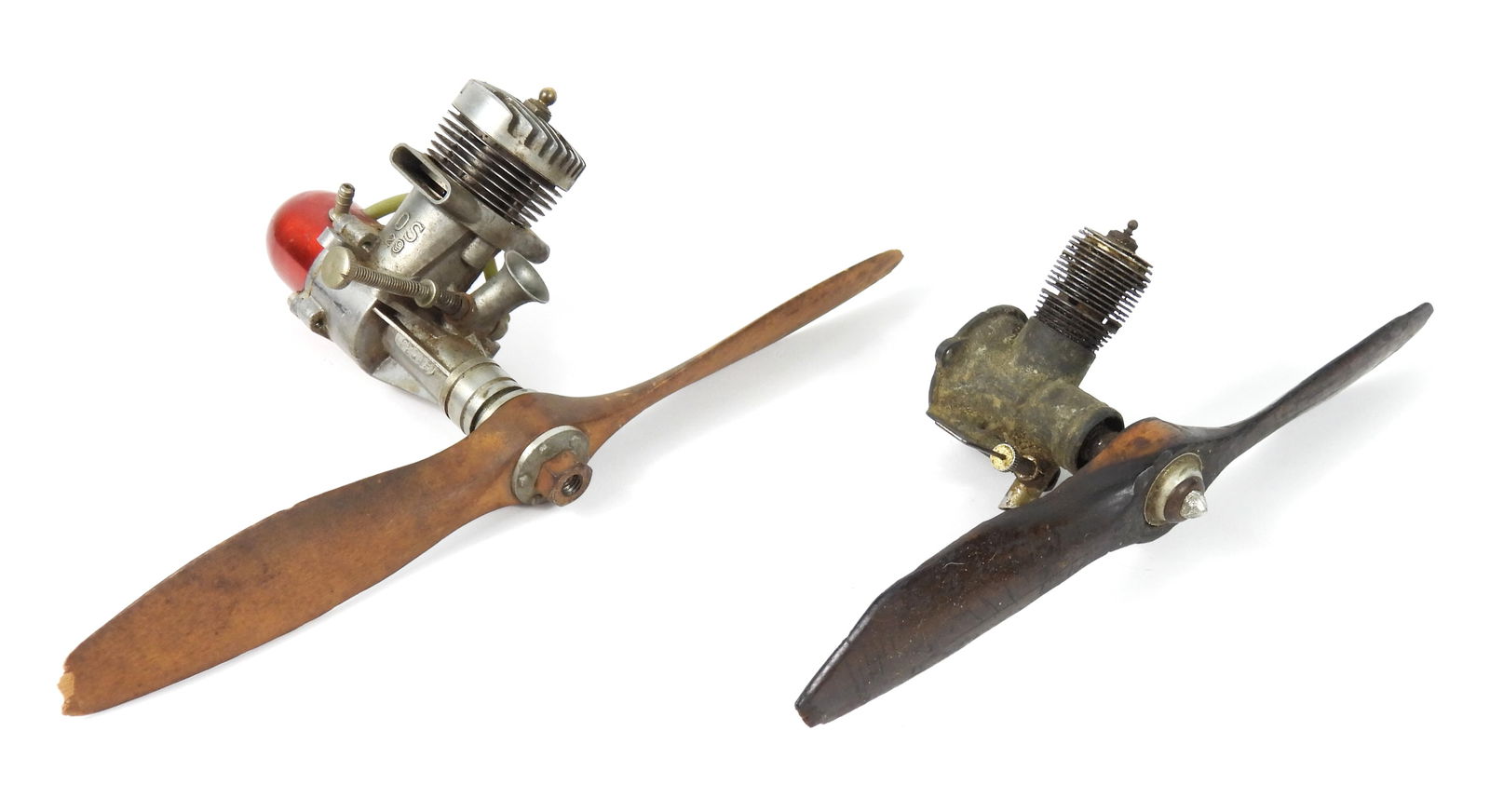 2PC Vintage Model Plane Engines: United States, Mid 20th Century, Metal, wood. Includes an OS Max 29 model plane engine with serial number 22145, and an Arden model plane engine. Smallest 3 1/4" t x 8 1/2" w x 3" d, Largest 3 1/4" t