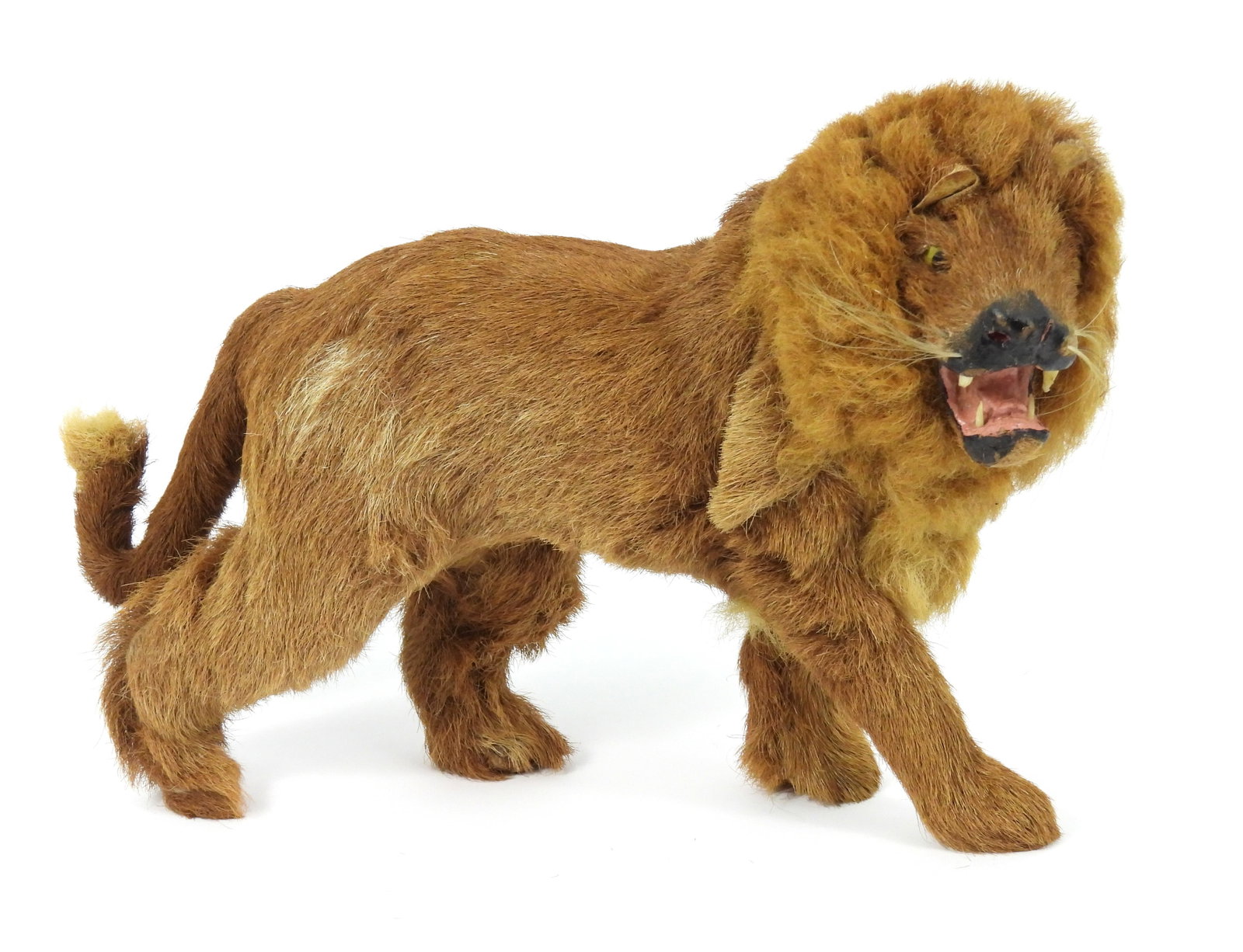 Antique Lion Children's Toy: Late 19th- Early 20th Century, Wood, fur. Antique lion toy with yellow glass eyes and open mouth revealing fangs. Approx. 8 1/2" t x 12 1/2" w x 4 1/2" d