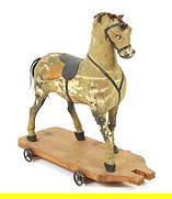 19C German Wood Horse Pull Toy: Germany, 19th Century, Wood, textile. White and black horse pull toy with black saddle and harness on a wood base. Approx. 15" t x 15" w x 6 3/8" d