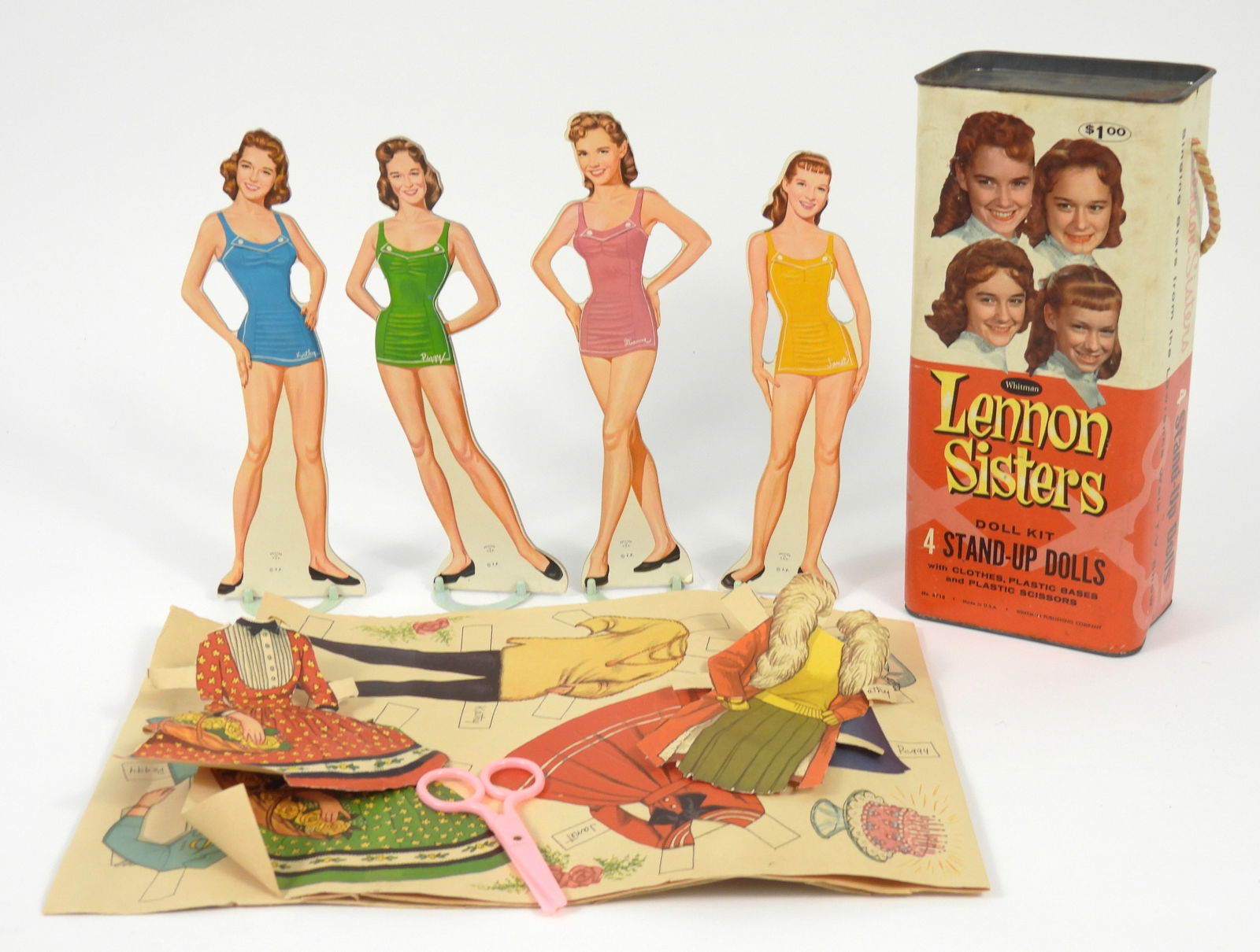 1960 Complete Lennon Sisters Cardboard Doll Set: United States, 1960, Print on paper. Includes all four sisters dolls, scissors, stands, and rolled paper cutout outfits. One corner of the paper roll has been cut off as pictured. Overall 10 1/2" t x