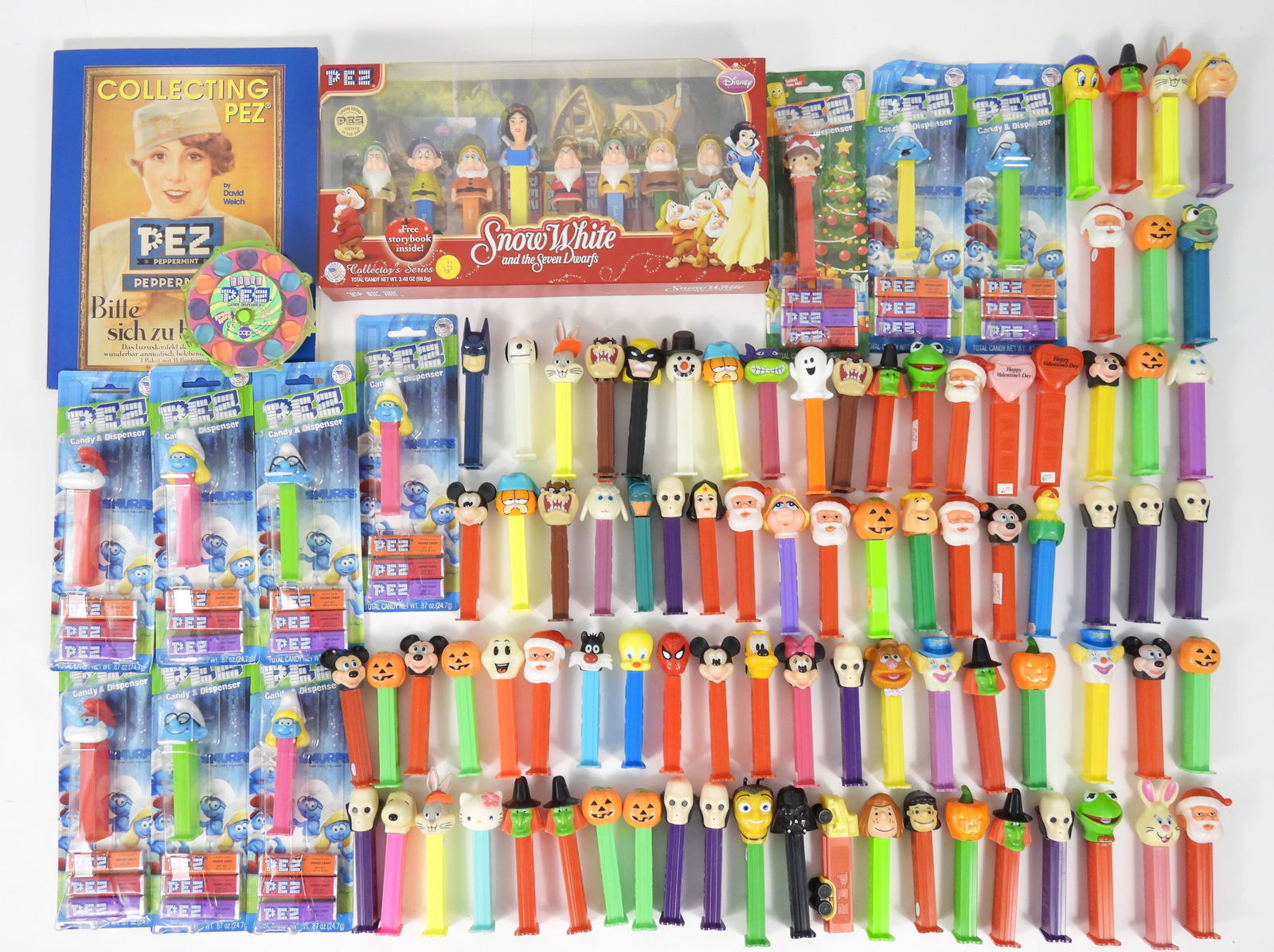 LG Vintage & Modern Pez Dispenser Collection: 20th Century. Large collection of character pez dispensers including Batman, Wolverine, the Muppets, Smurfs, Looney Tunes, Clowns, Disney, holiday, and Hello Kitty.