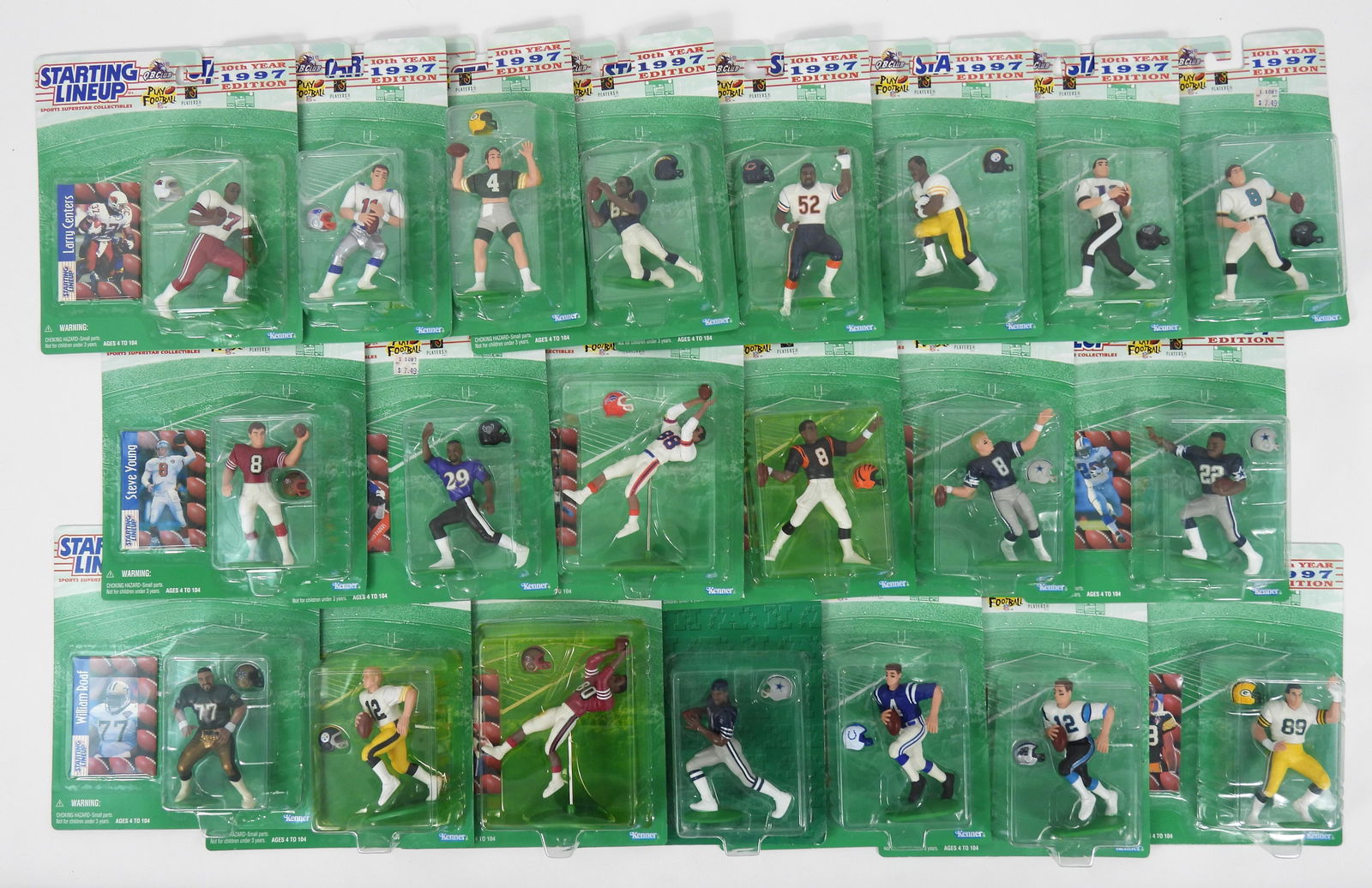 21PC Kenner Starting Lineup Football Figures: Twenty one Kenner Starting Lineup football figures including Jeff Blake, Mark Chmura, William Roaf, Tony Martin, Kerry Collins, and Jerome Bettis amongst others. Each 9" t x 8" w x 2" d