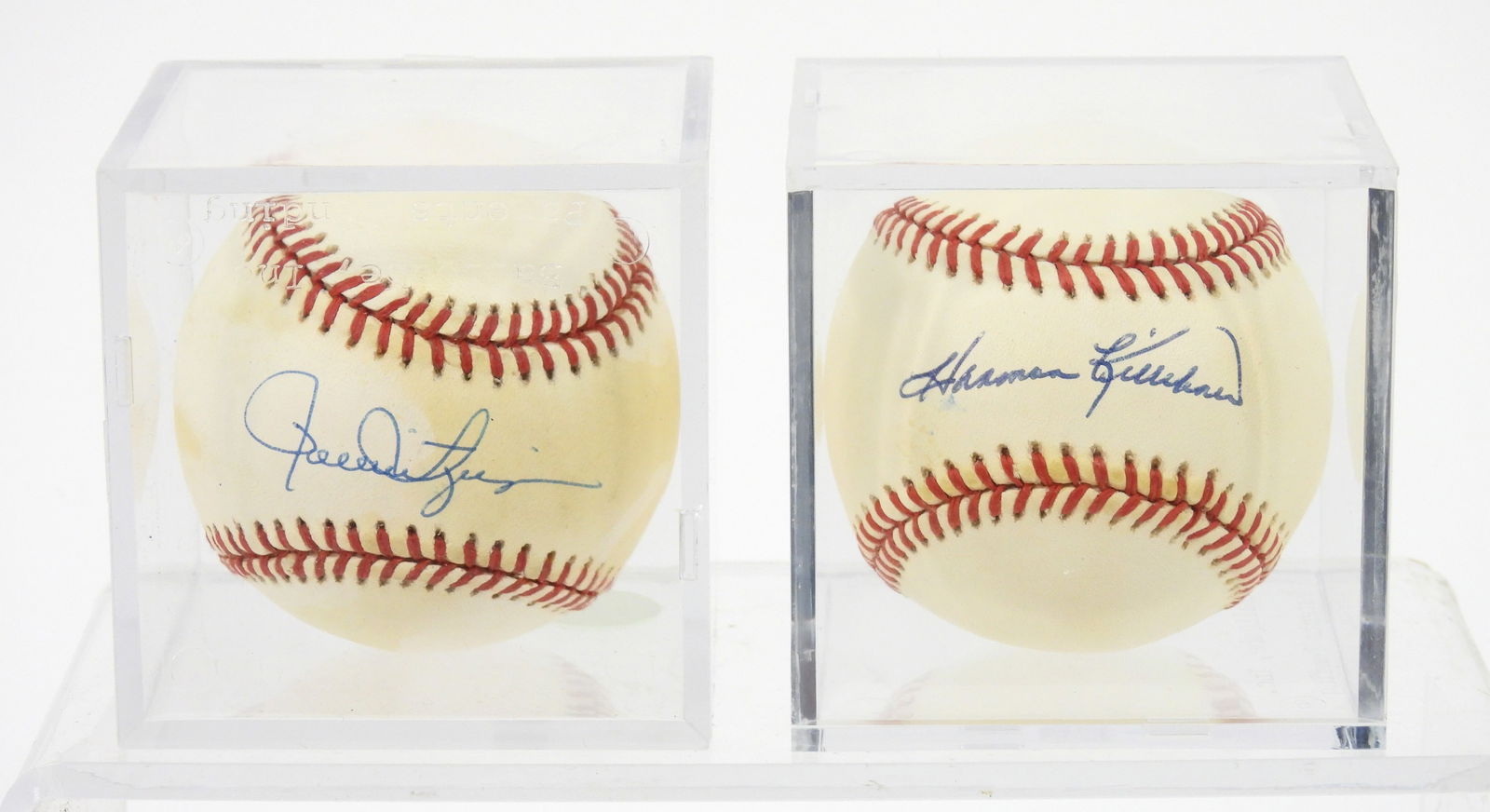2PC MLB Killebrew & Rollie Fingers Signed Balls: Two cased Rawlings Baseballs signed in blue ink by Hall of Fame players Harmon Killebrew and Rollie Fingers. No COA included, likely event signed during the 1990s for owner.