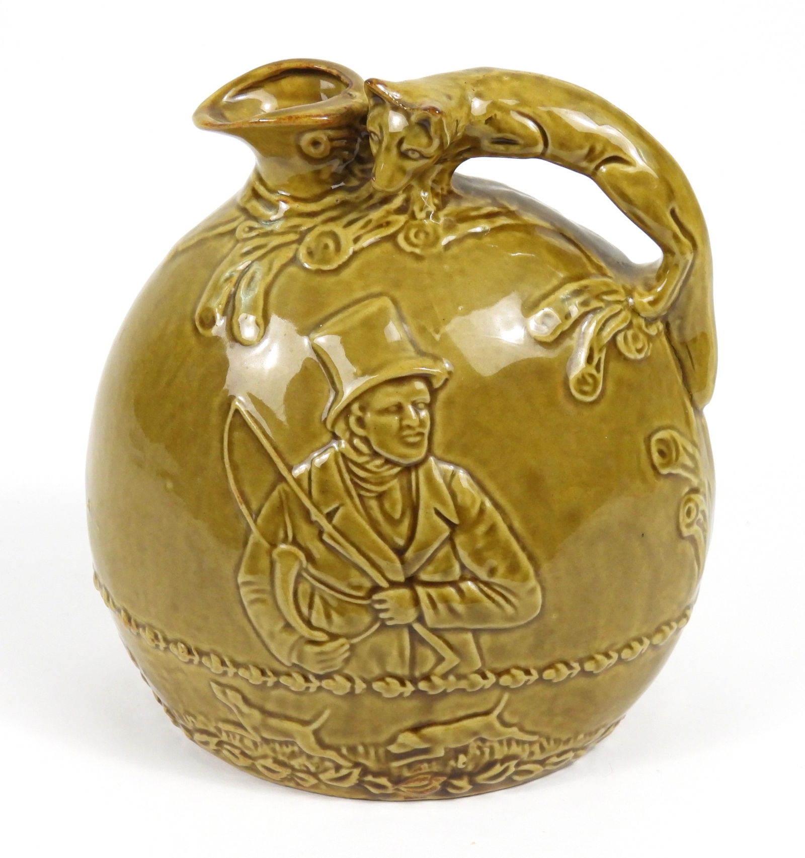 Rockingham Pottery Fox Hunt Jug: England, Early 20th Century, Pottery. Pottery jug with figural fox handle featuring a gentleman with a top hat on one side and group of hunters with horses on the reverse in a mustard yellow glaze. Ap