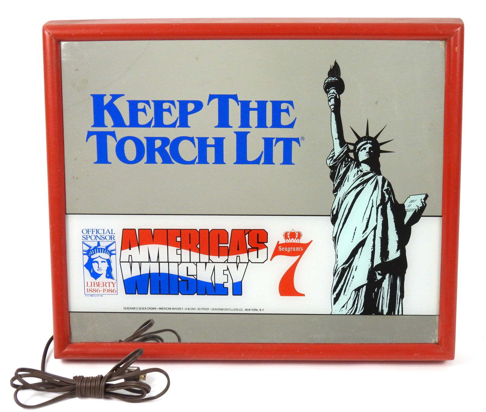 Seagram's Light Up Mirrored Bar Sign: United States, 20th Century, Metal, glass. Seagram's mirrored light up bar sign depicting the Statue of Liberty that reads "Keep the Torch Lit America's Whiskey" surrounded by a red frame. Approx.