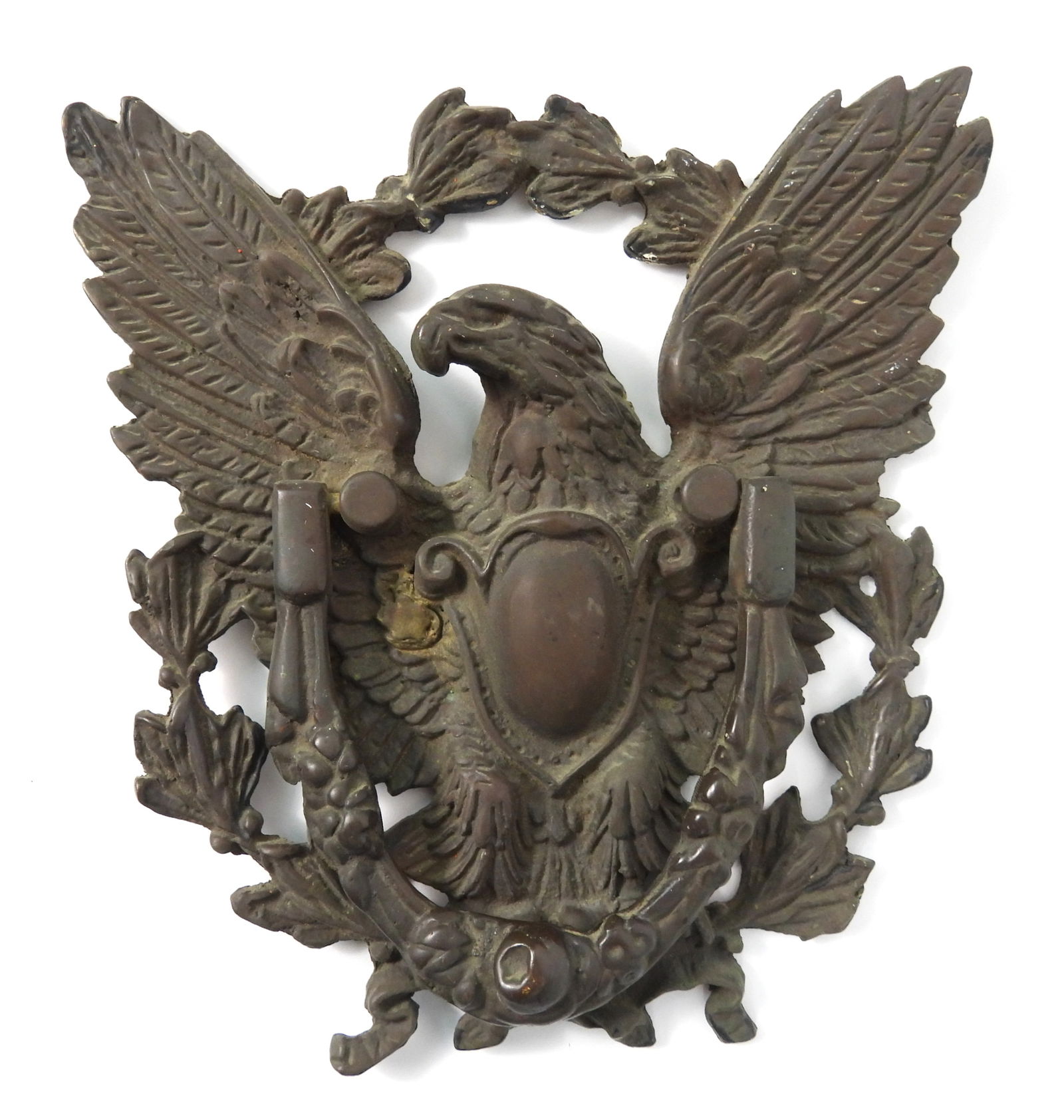 LG Brass Eagle Door Knocker: United States, 19th Century, Brass. American eagle brass door knocker with outstretched wings, a shielded breast, and surrounded by a laurel. Approx. 9" x 8 1/4"