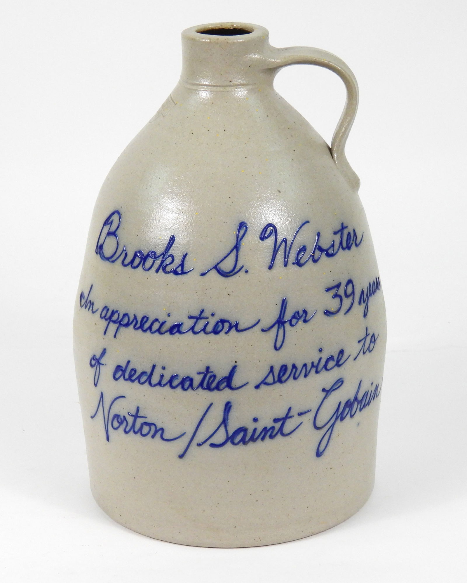 Salmon Falls Stoneware Crock Jug: New Hampshire, 2004, Stoneware. Stoneware crock decorated with a cobalt blue floral design and marked "Brooks S. Webster In Appreciation For 39 years of dedicated service to Norton/ Saint-Gobain".