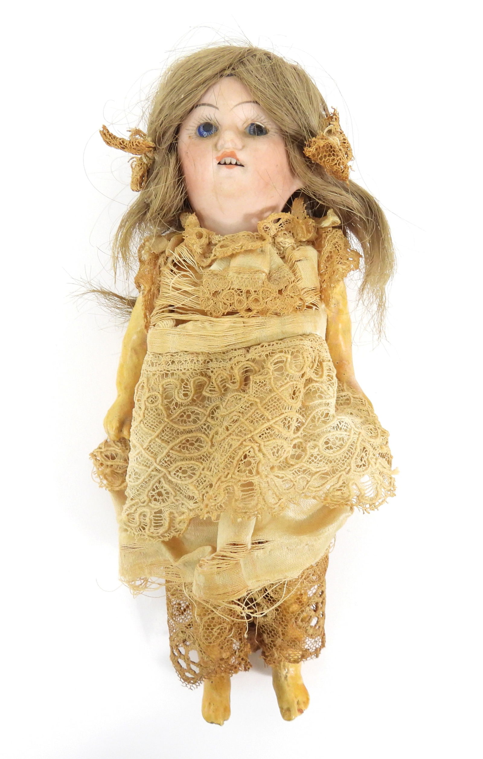 19C French Bebe Bisque Headed Doll: France, 19th Century, Bisque, composite. Bisque headed doll with composite body, painted lashes, open mouth, blue painted glass eyes, and muted blonde hair dressed in lace. Approx. 7 5/8" tall