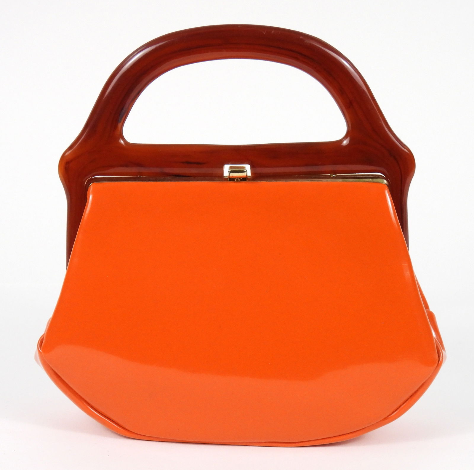 MCM Orange Vinyl & Lucite Handled Handbag: Mid 20th Century, Lucite, vinyl. Tortoise style Lucite handled bag with vivid orange vinyl body, gold colored hardware, and multicolored cotton lining. Approx. 9 1/2" t x 9 1/4" w x 2 1/2" d