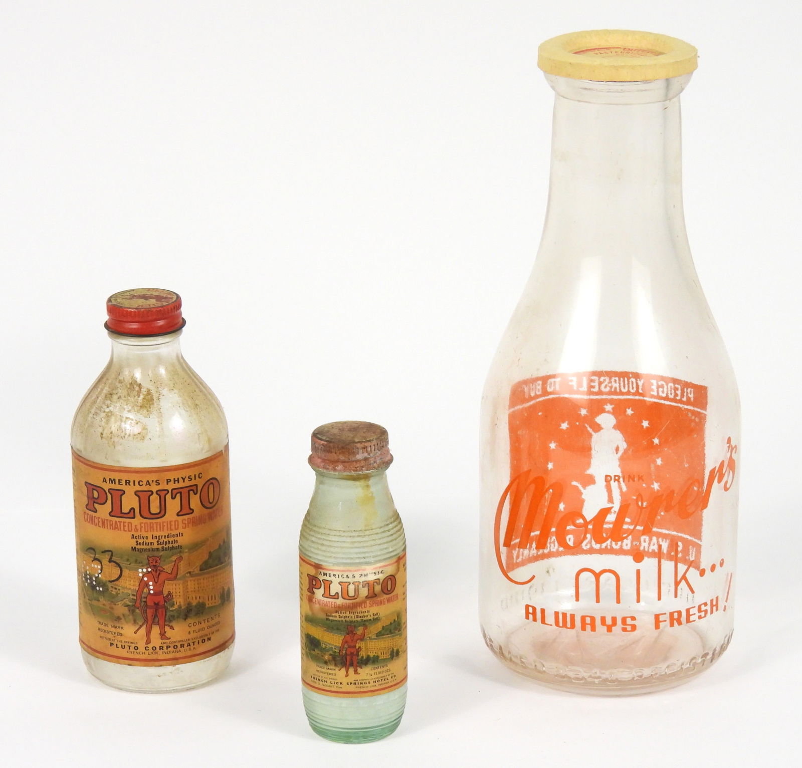 3PC Antique Glass Bottles: United States, Early 20th Century, Glass. Includes a Mower's Milk bottle with a War Bonds advertisement to one side, a 2 1/4 floz Pluto Spring water bottle, and an 8 floz Pluto Spring Water bottle