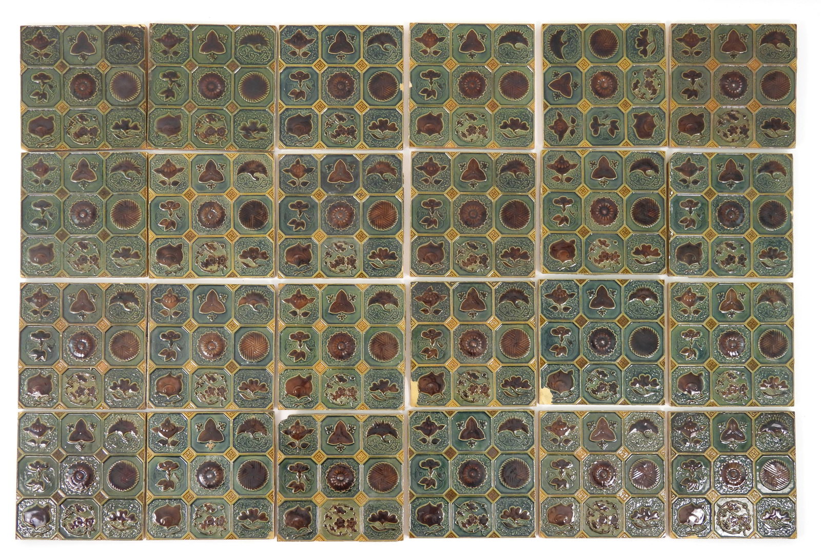 24PC Victorian Era Majolica Ornate Tiles: Late 19th-Early 20th Century. Unmarked Art Nouveau style Majolica tiles decorated with good luck symbols and floral designs.. Each measures 6" x 6" with and approx. depth of 1/2".