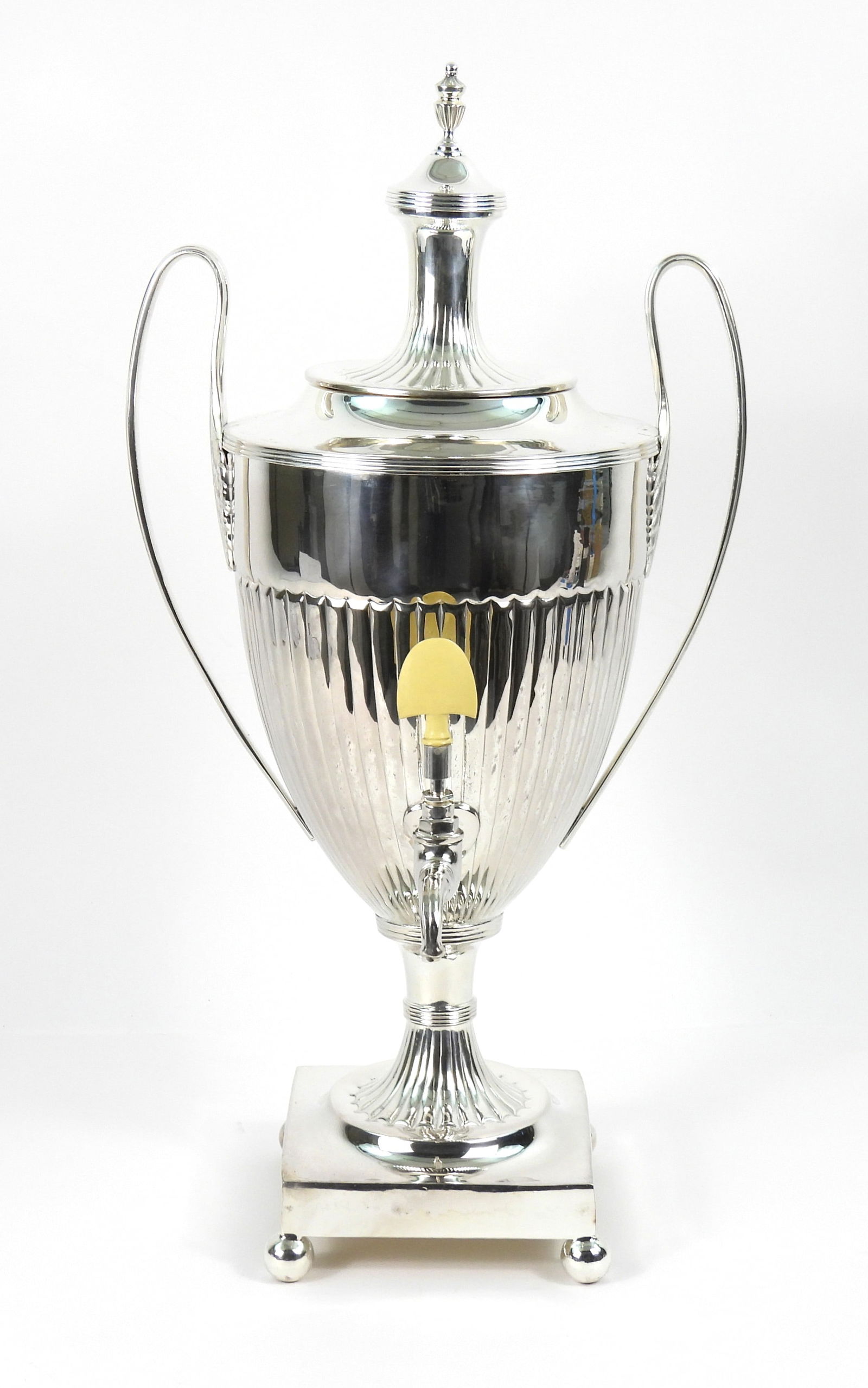 LG International Silver Plate Coffee Tea Urn: Mid 20th Century, Silver plate. English fluted form with ball feet and bone dispense handle. Unused in a wood shipping box. Urn 24 1/2" t x 12" w x 11" d, Crate 22" t x 12" w x 12" d.