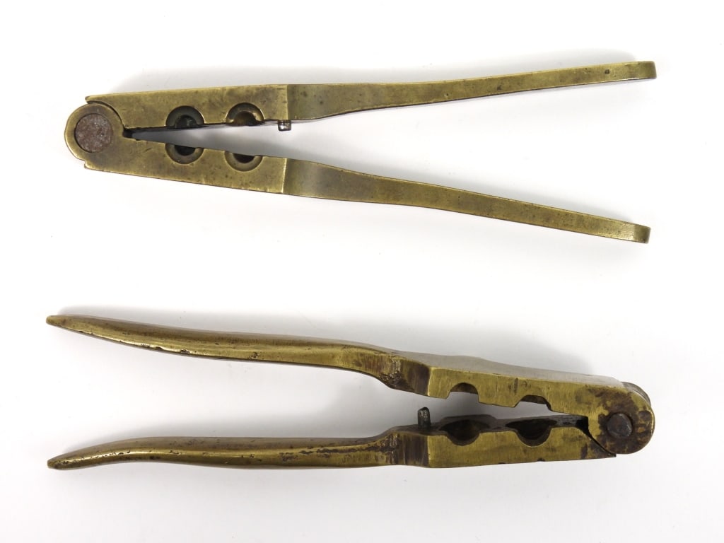 Two Brass Pistol Bullet Molds: A brass mold with cavities for a .36-caliber ball and conical bullet; and a bass mold with very light Colt markings with cavities for .32-caliber ball and conical bullet.