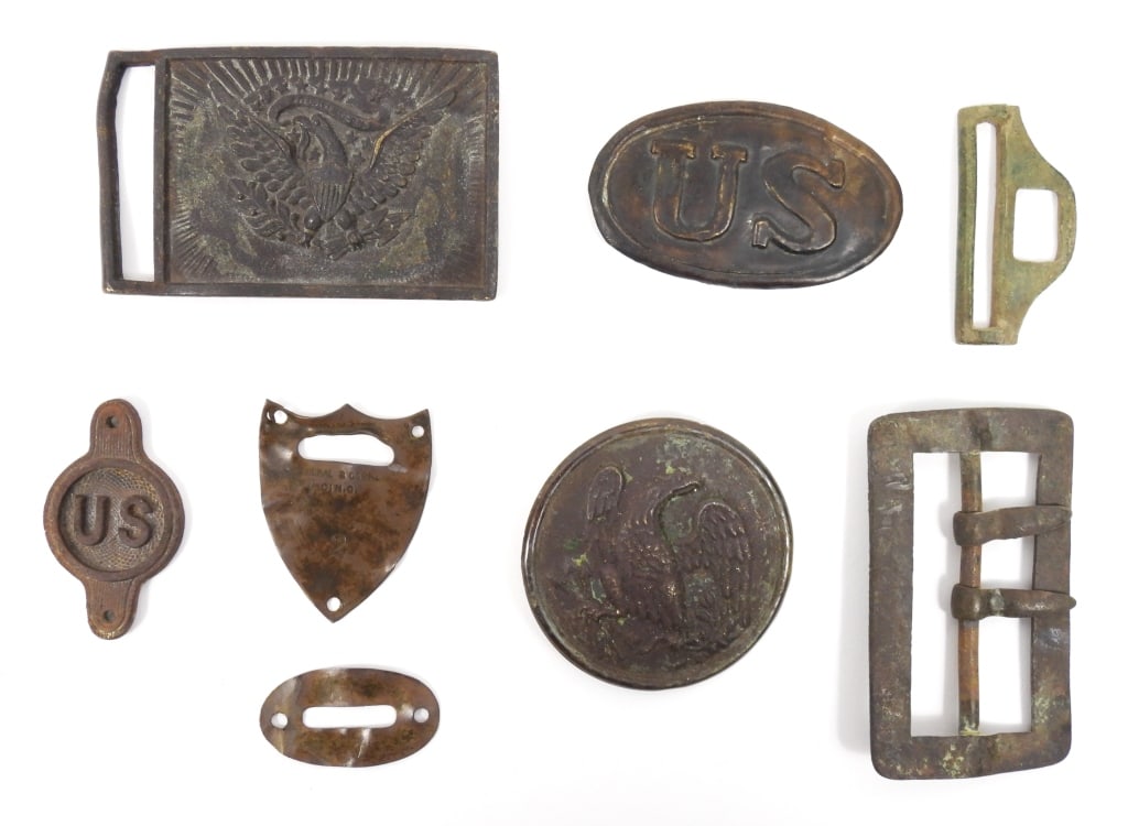 Group of Dug Civil War Belt Plates and Artifacts: A lead-filled brass eagle breast plate with one iron wire loop left on the back; a steel bridle rosette; a small-size Model 1839 US belt plate with missing hooks; a brass carbine sling buckle; a