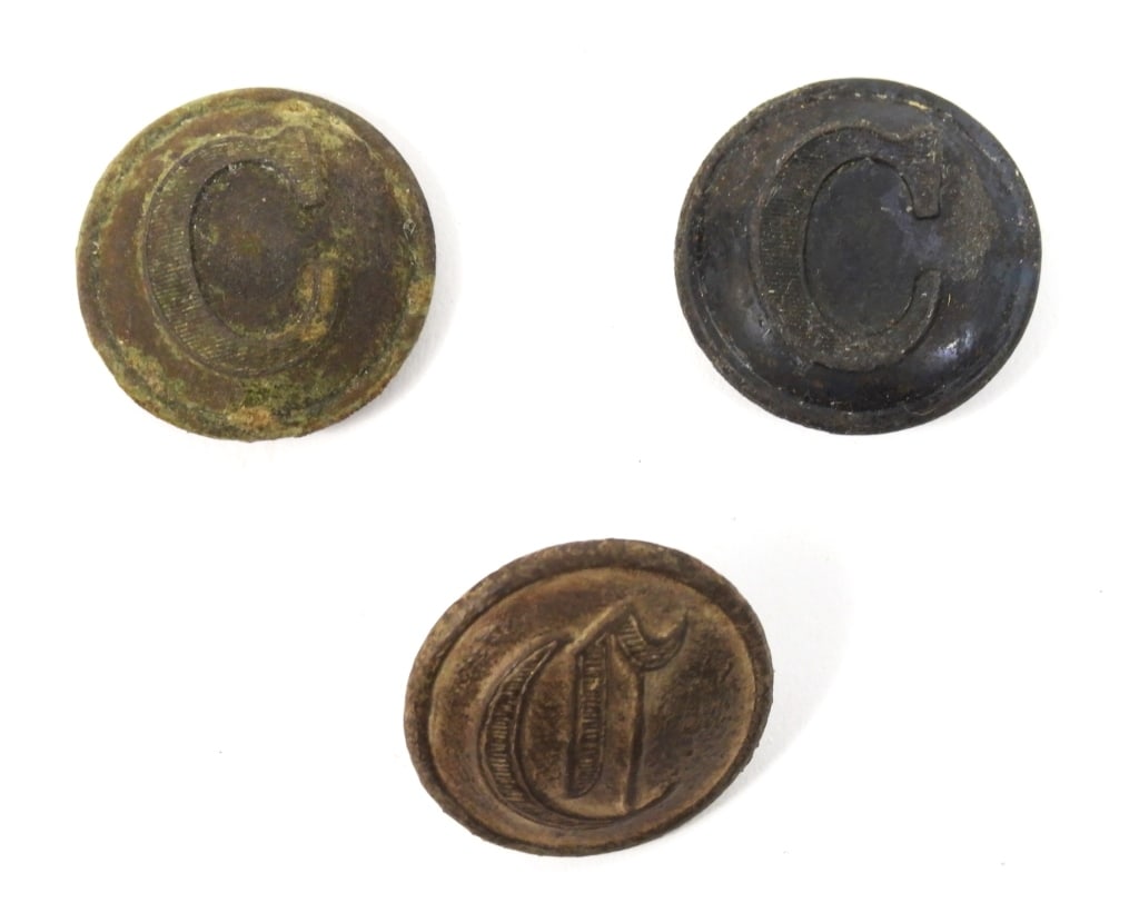 Three Dug Confederate Cavalry Buttons: A coat-size block "C" button with bent but intact shank and marked "SUPERIOR/QUALITY" (22.7mm); a coat-size block "C" button with remnants of the back (22.7mm); and a coat-size script "C" button with