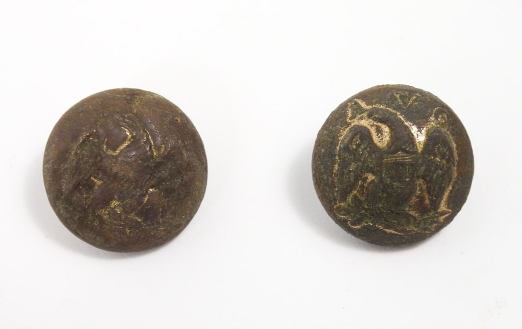 Two Dug Alabama Buttons: A coat-size Alabama Volunteer Corps button with an eagle and "AVC" with an intact shank and an illegible back mark (20.6mm); and a Mobile Volunteer Corps button with an eagle and "MVC" with an intact