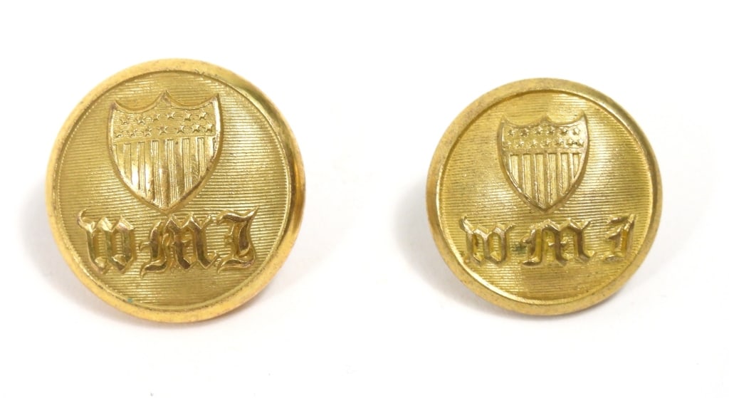 Two Western Military Institute Buttons: A coat-size gilt-brass button with a shield over "WMI" and a "SCOVILL MF'G CO/WATERBURY" back mark (22.9mm); and a coat-size gilt-brass button with a shield over "WMI" and a "SCOVILL MF'G