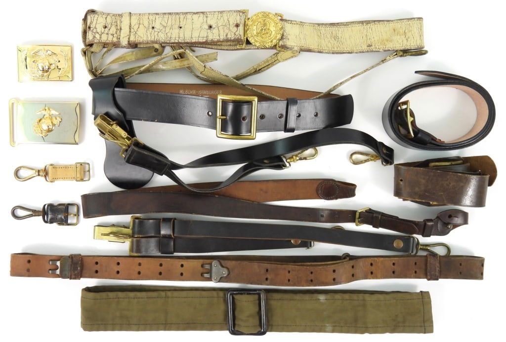Group of Military Belts, Sling, and Buckles: A late 19th century US Navy sword belt; a black leather waist belt with a brass buckle; a brass US marine Corps belt buckle with detachable eagle, globe, and anchor; a one-piece brass US Marine Corps