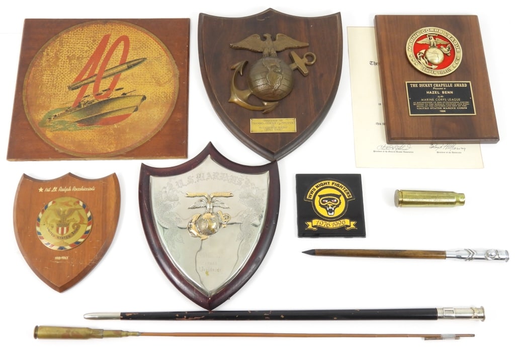 Group of Presentation Plaques and Swagger Sticks: A US Marine Corps table plaque with a silver plated shield with Korean dragons, eagle, globe, and anchor, and marked "NoRmand/Ernest/Veillete"; A shield-shaped wall plaque marked "1st Lt. Ralph