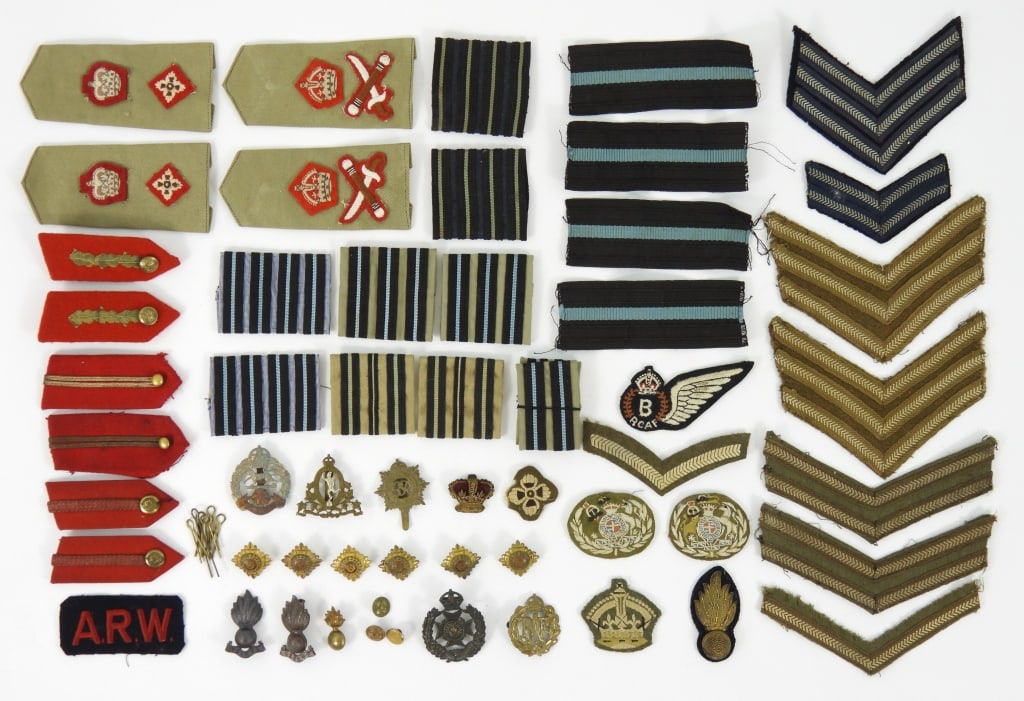 Group of WWII Commonwealth Insignia: Officers collar tabs; cap insignia; pips; stripes; slip on shoulder strap insignia; and a Royal Canadian Airforce Bomb Aimer patch.