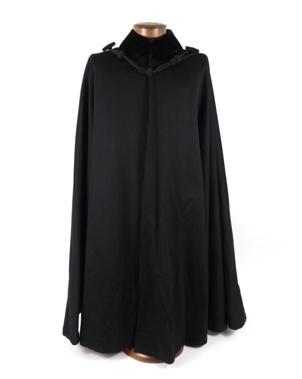 US Navy Boat Cloak: Dark blue wool boat cloak with a rolling collar of dark blue velvet with a double hook and eye closure, a set of mohair frogs with loops and toggles secure the front of the cloak, and a dark blue wool