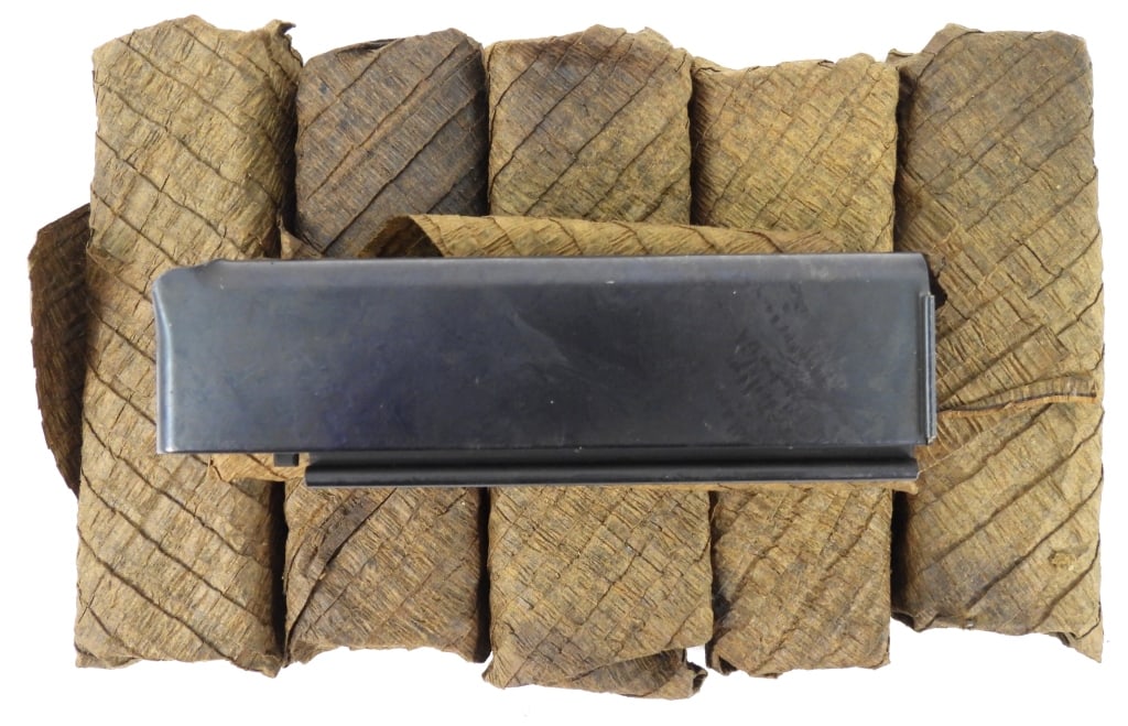 Six Patent Date Thompson SMG Shot Magazines: Six patent date Thompson SMG magazines in a paper wrapping marked "PATENTED-AUG. 24, 1920/FOR 18 SHOT CARTRIDGES/AUG 24, 1920.-JAN. 11, 1921".Disclaimer and lot information: Many states restrict or