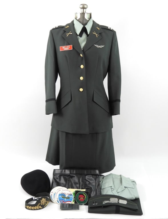 Ladies Uniform of Captain Ella M. Nelles, US Army: A green tunic with brass buttons, captains bars on the shoulder straps, "U.S." and crossed rifles on the collar and lapels, and wings on the left breast, a pair of matching trousers, a matching