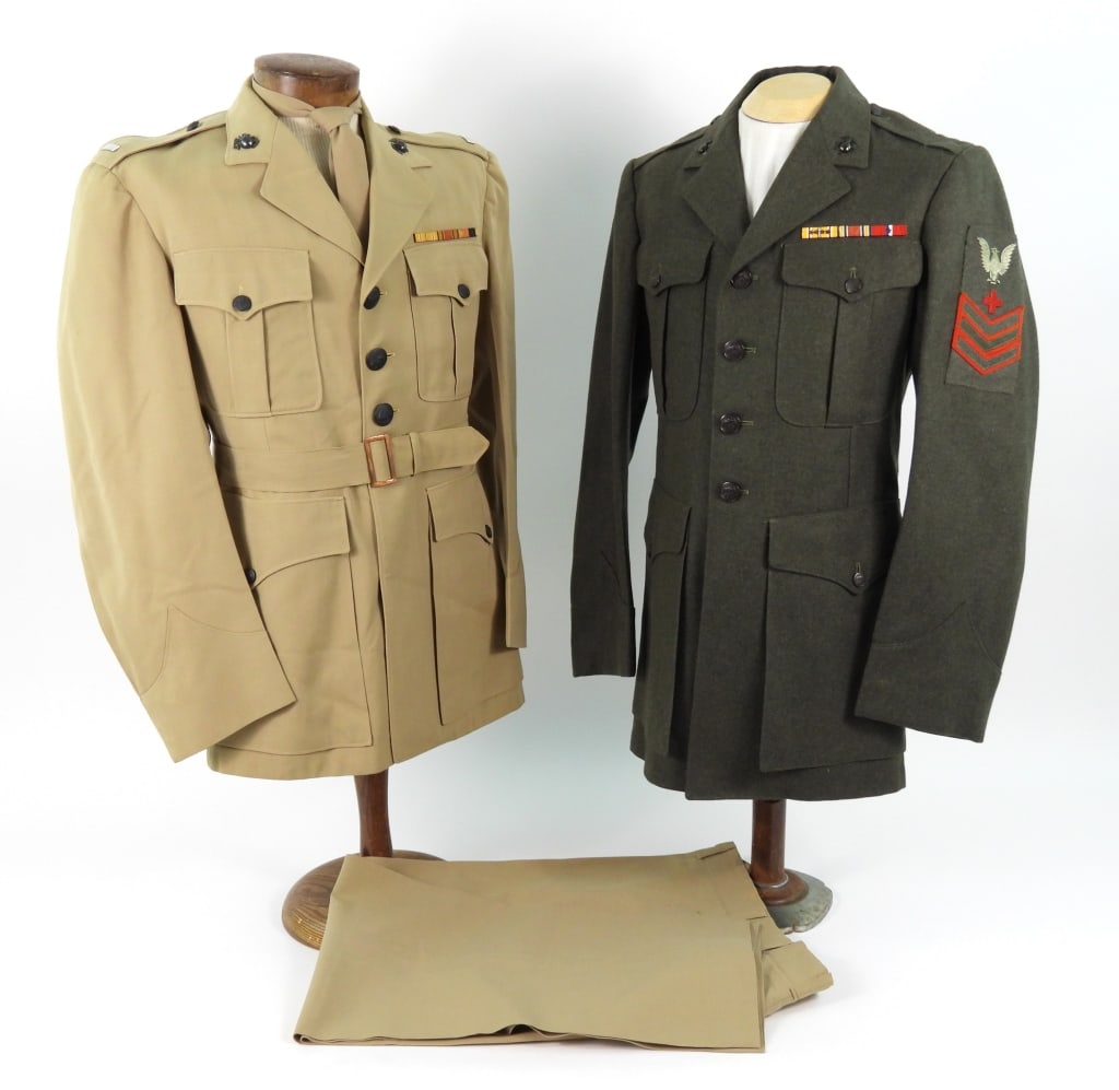 Two USMC Uniforms: A khaki twill woven wool summer officers tunic with brown plastic buttons, 1st lieutenant's insignia on the shoulder straps, eagle, globe, and anchor insignia on the collar, ribbon bar above the left